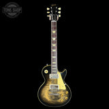 Electric guitar with a sunburst finish on a black background, featuring the Gibson logo.