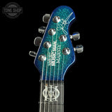 Guitar headstock with blue glitter finish and 'Musician's Majesty' branding on a black background.