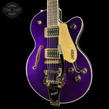 A purple Gretsch electric guitar with gold hardware and a cream pickguard, shown against a solid black background. The Tone Shop logo is visible in the top left corner.