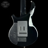 Black electric guitar with a visible brand logo on a black background