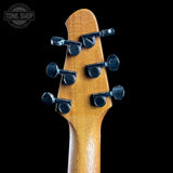 Guitar headstock with tuning pegs on a black background, featuring the Tone Shop logo.