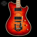 Electric guitar with a red flame finish on a black background, featuring the Tone Shop logo.