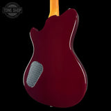 Red electric guitar with a visible brand logo on a black background