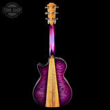 Purple acoustic guitar with a visible brand logo on a black background