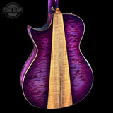 Purple electric guitar with a visible brand logo in the corner