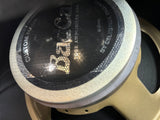 Close-up of a speaker cone with 'B & K' branding on a dark background