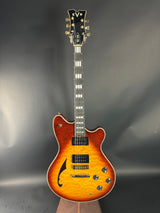 Electric guitar with a sunburst finish on a gray background
