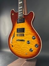 Electric guitar with a sunburst finish on a dark background