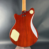 Wooden electric guitar with a wavy design on a gray background
