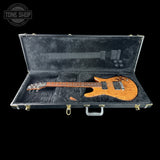Electric guitar in a hard-shell case with 'Tone Shop' branding.