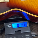 Gibson Custom 1959 Les Paul Standard Reissue Ultra Light Aged Southern Fade on scale displaying weight.