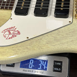 Guitar being weighed on a digital scale with a visible brand logo.