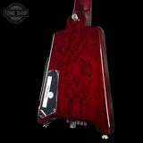 Red electric guitar body with 'Tone Shop' logo in the corner