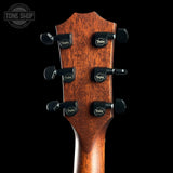 Guitar headstock with tuning pegs on a black background, featuring the Taylor logo.