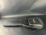 Guitar case with a brand logo on a reflective surface