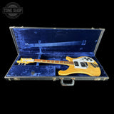 Yellow electric guitar in a blue case with 'Tone Shop' logo.
