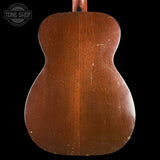 Back of a wooden acoustic guitar with 'Tone Shop' logo in the corner.