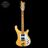Electric guitar with a blonde finish on a black background, featuring the Tone Shop logo.