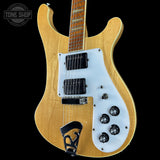 Electric guitar with a blonde finish and white pickguard on a black background, featuring the Tone Shop logo.