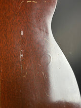 Close-up of a wooden object with visible grain and surface texture.