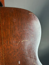 Close-up of a wooden object with visible grain and texture on a gray background