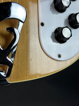 Close-up of a guitar's control knobs and bridge