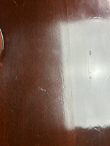 Close-up of a wooden surface with a white rectangular patch