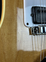 Close-up of a guitar's bridge and strings