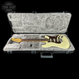 Electric guitar in a hard-shell case with 'Tone Shop' logo.
