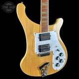 Electric guitar with a blonde finish and white pickguard on a black background, featuring the Tone Shop logo.