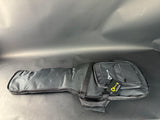 Gray guitar case with a brand label on a reflective surface