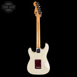 White electric guitar with a visible brand logo on a black background