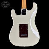 White electric guitar with a visible brand logo on a black background