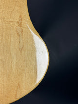 Close-up of a wooden paddle with a white blade on a dark background