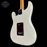 White electric guitar with a visible brand logo on a black background