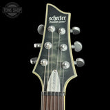 Guitar headstock with Schecter branding on a black background
