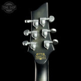 Guitar headstock with tuning pegs on a black background, featuring the Tone Shop logo.