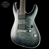Electric guitar with a marbled finish on a black background, featuring the Tone Shop logo.