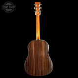 Back view of a wooden acoustic guitar on a black background with 'Tone Shop' branding.