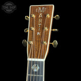 Close-up of a Martin guitar headstock on a black background