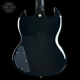 The back of a glossy black electric guitar, showing the body contour, gold hardware, and a white background with a Tone Shop watermark in the top left corner.