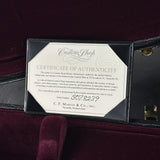 A Certificate of Authenticity insert for a Martin Gutar custom shop guitar, displayed inside an open black case lined with deep burgundy velvet.