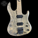 Wooden electric guitar with a 'Tone Shop' logo in the corner