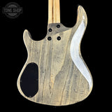 Wooden guitar body with a black pickguard and white inlay on a black background, featuring 'Tone Shop' logo.
