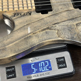 Used Kiesel Osiris 6 Swamp Ash on scale displaying weight.