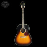 Acoustic guitar with a sunburst finish on a black background, featuring the Tone Shop logo.
