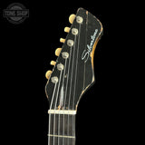Close-up of a guitar headstock with 'Silvertone' branding on a black background.