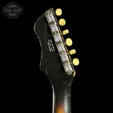Guitar headstock with tuning pegs on a black background, featuring 'Tone Shop' logo.