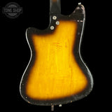 Back view of a guitar with a sunburst finish on a black background, featuring the 'Tone Shop' logo.