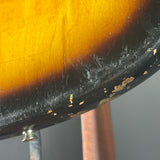 Close-up of a guitar's tortoiseshell pickguard with a dark gray background